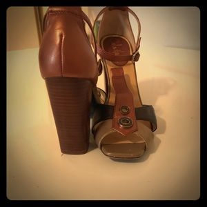 Cole Haan bronze heels with button details.