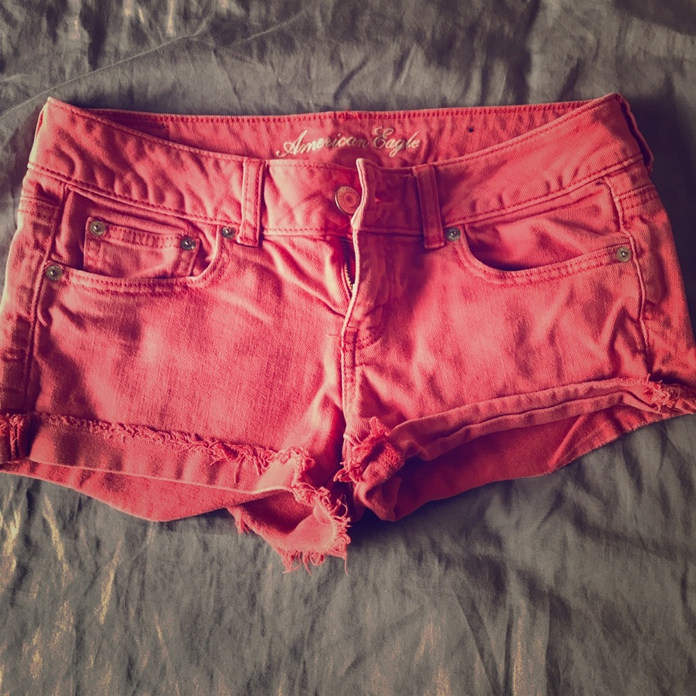 American Eagle orange short shorts.
