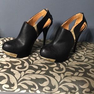 Like new black Cupid heel with gold studs.