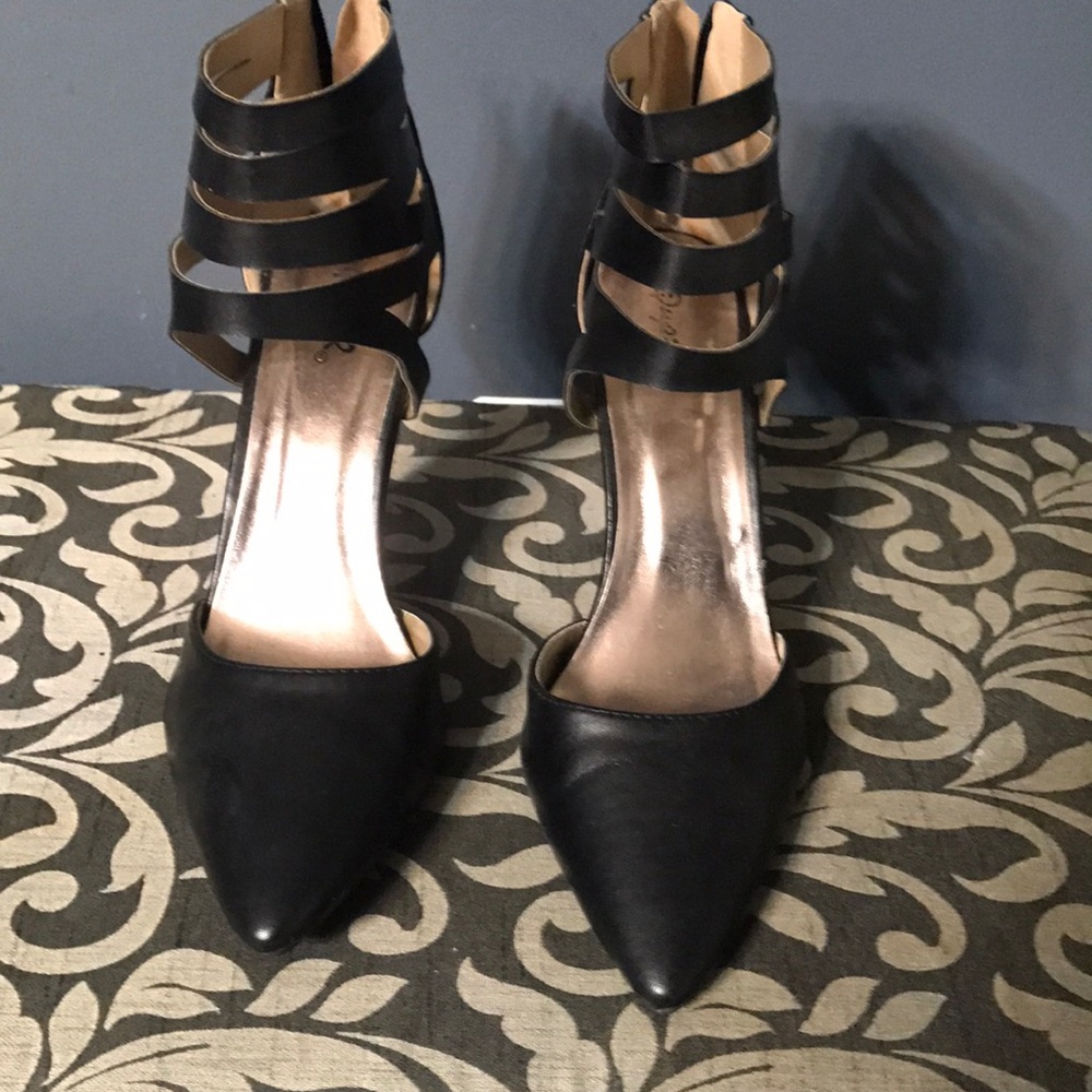 Black heels with ankle straps.
