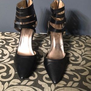 Black heels with ankle straps.