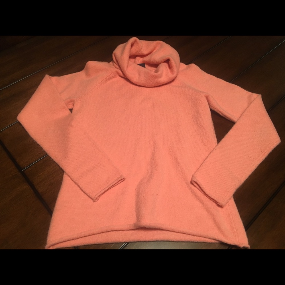 Slightly worn coral sweater with a cowl neck.