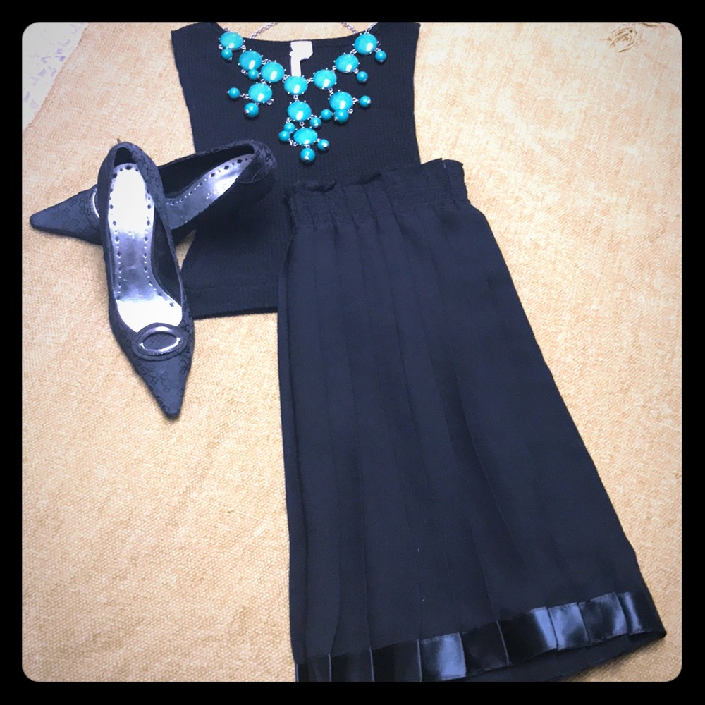Black pleated skirt. Reads one size.