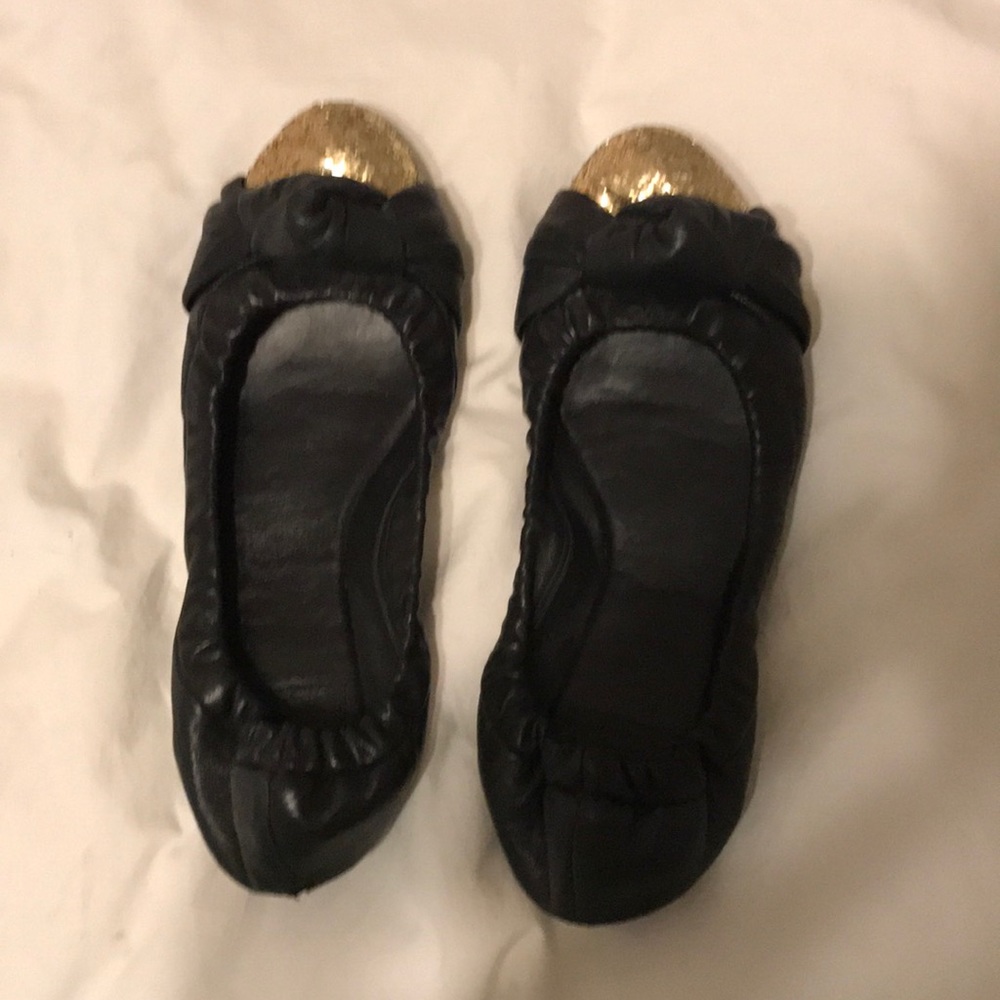 Black Tory Burch flats with gold sequin toes