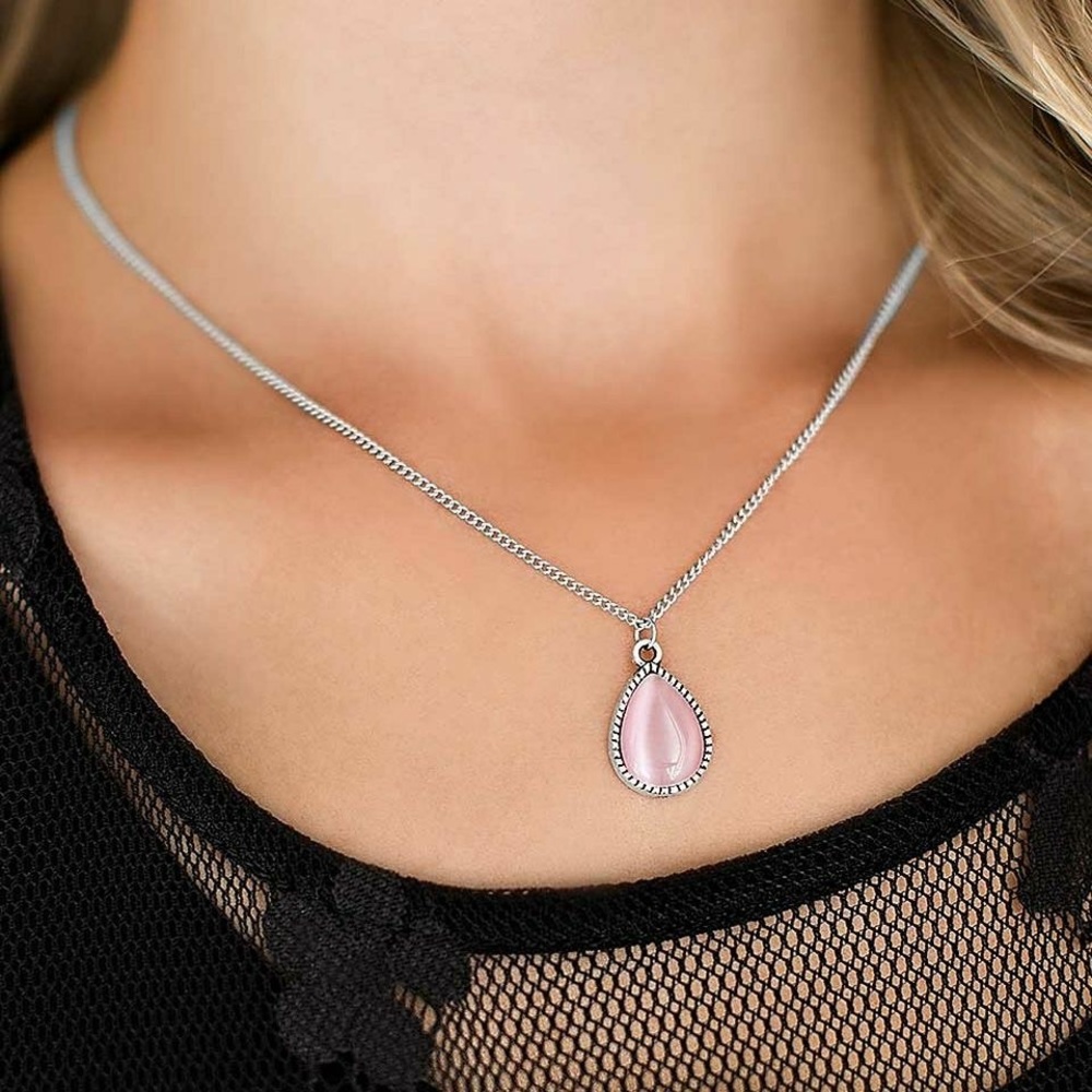 Silver necklace with pink pendant.