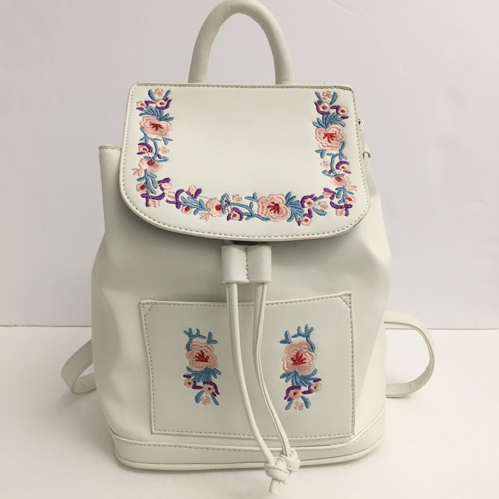 White, faux leather backpack.