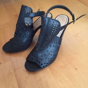 Women's pair of black peep hole shoes