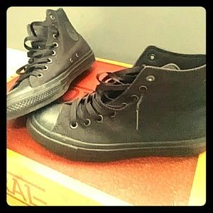 Black on black high-top Chuck Taylor Converse