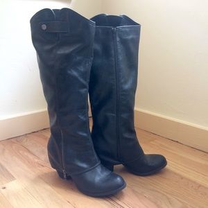 Black zip boots. Below the knee.