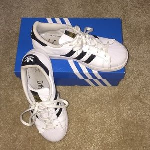 Black and white Adidas Superstars