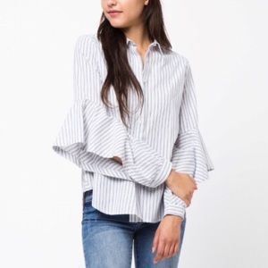Statement sleeves button up top. Pinstripes