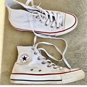 White converse with one hole and smeared tag
