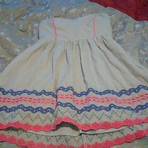 A pink, cream, blue, amd silver midi dress