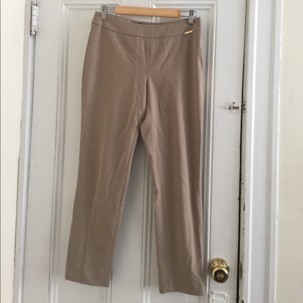 Beige tailored trousers / suit pants.