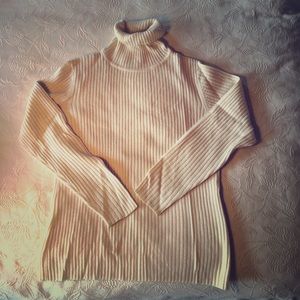 Cream-colored turtleneck sweater. Brooks Brothers.