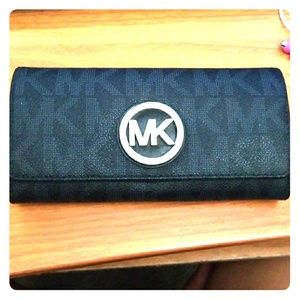 100% authentic Michael Kors black leather wallet.