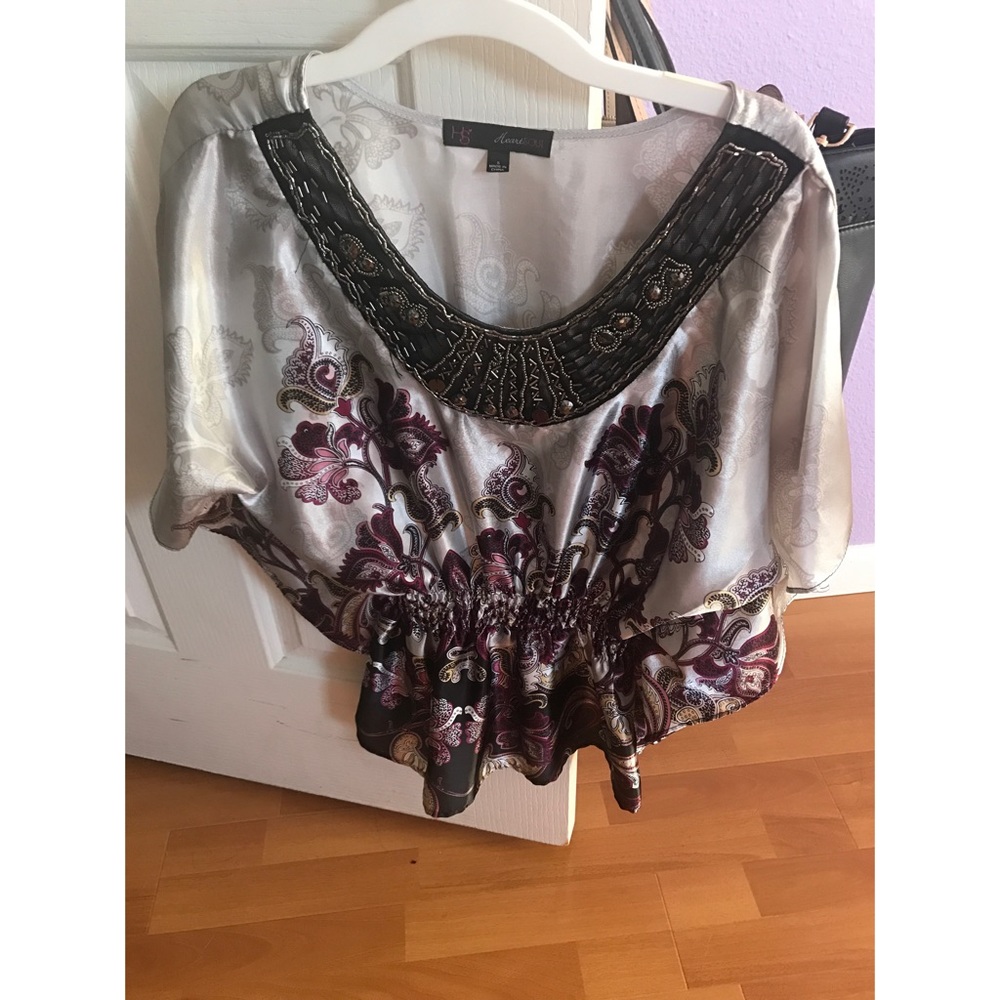 Shiny silver party top with floral designs