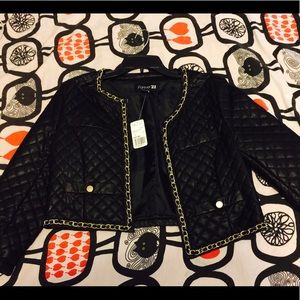 Quilted pleather jacket with gold trim.