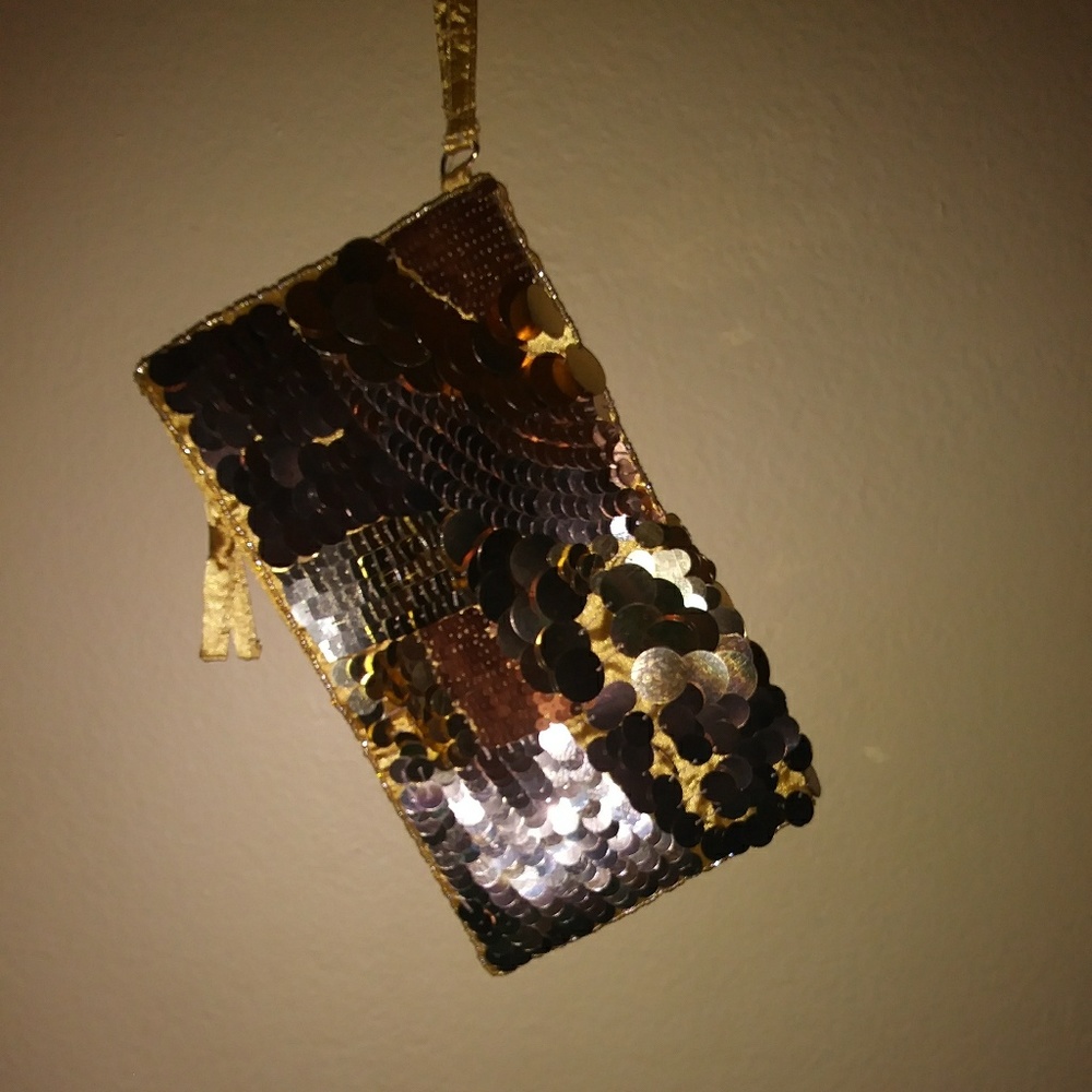 A gold sequence cluch purse.