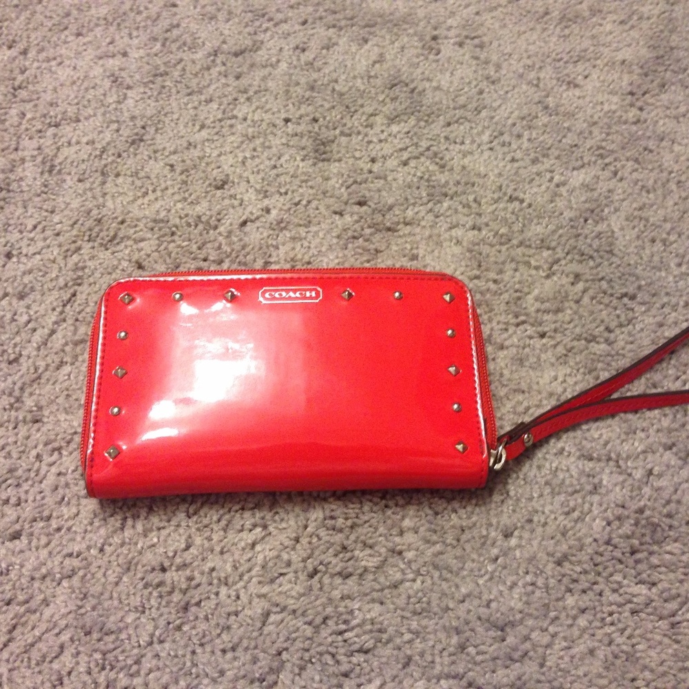 Red studded Coach wristlet with studs