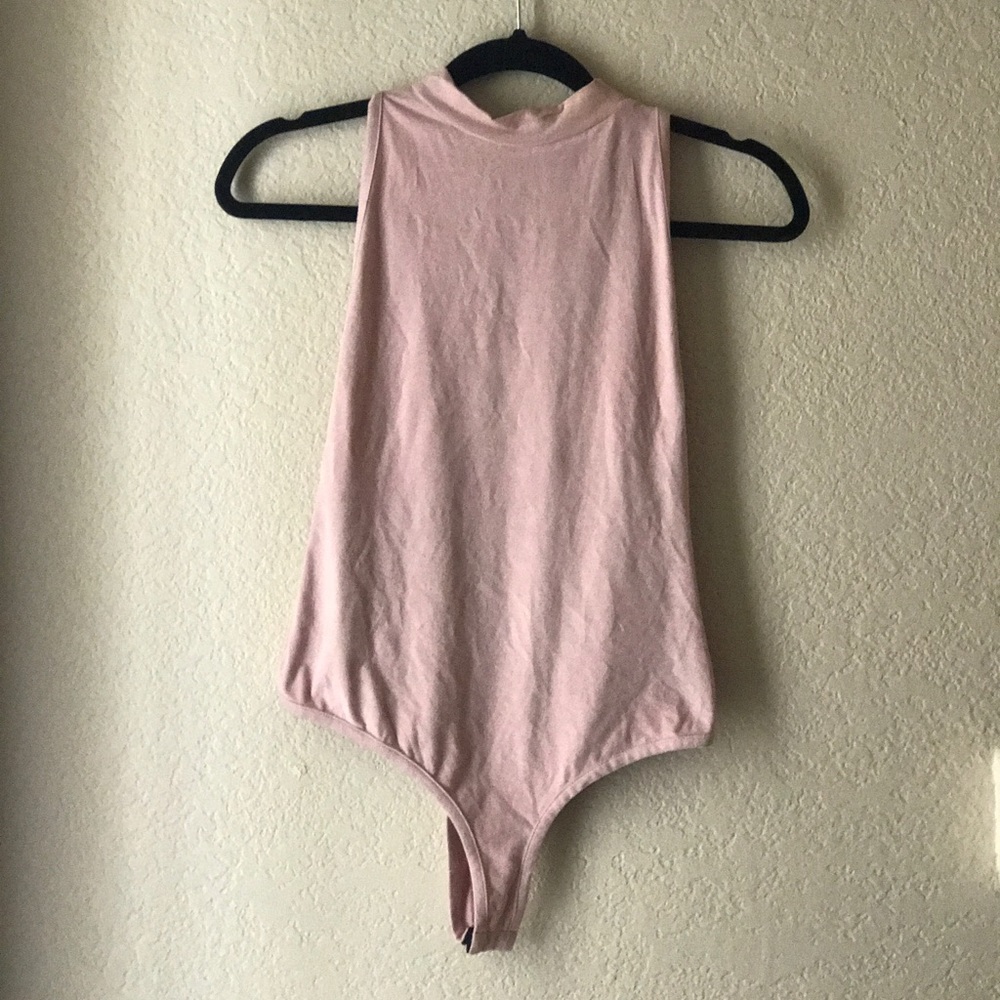 Pale pink faux suede body suit. Never worn!