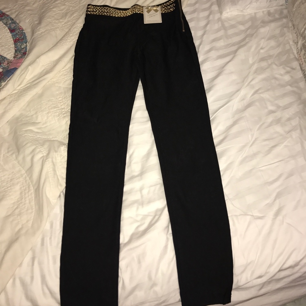 Black high waisted pants gold belt around waist