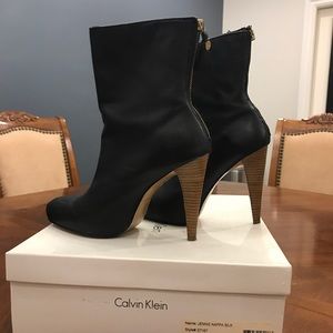 Black leather booties with gold zippers