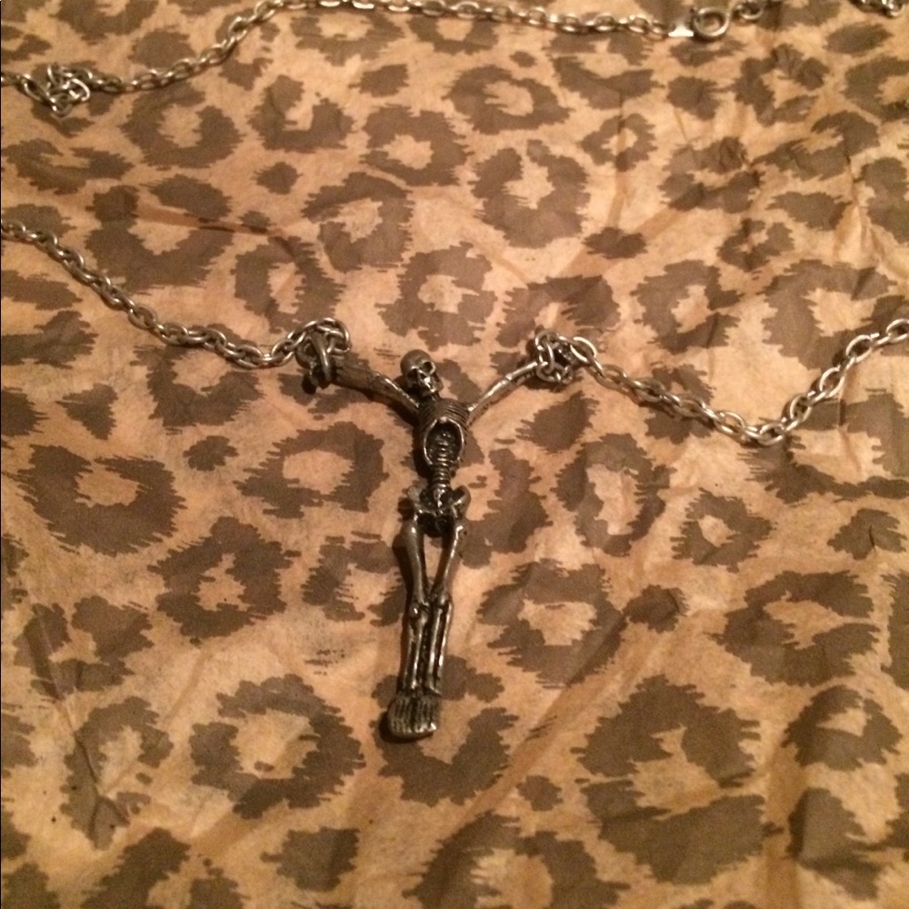 A skeleton cross necklace.