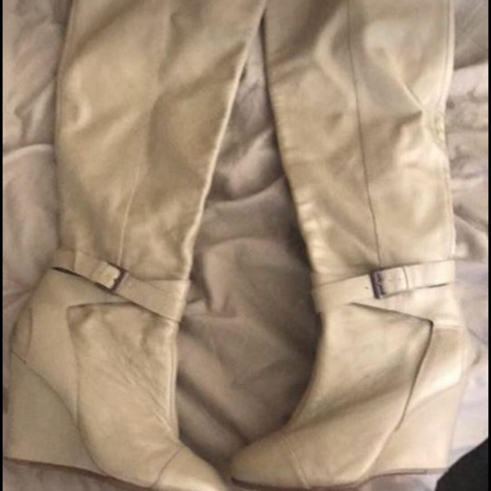 Knee high cream high heeled boots