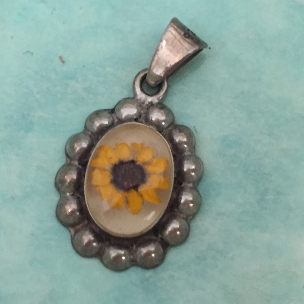 Sterling silver and pressed flower pendant.