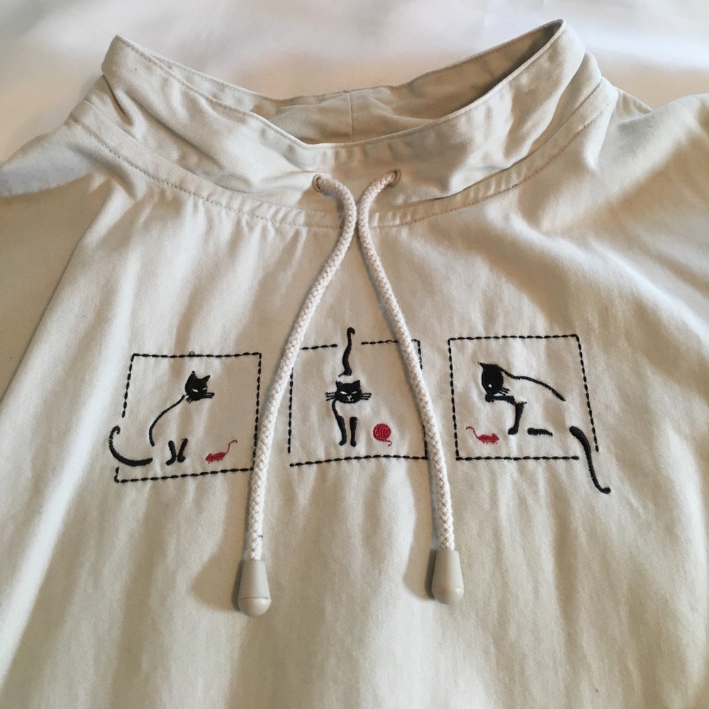 Pullover cotton top features playful kittens.