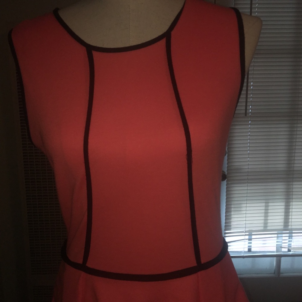 Coral peplum dress with black piping