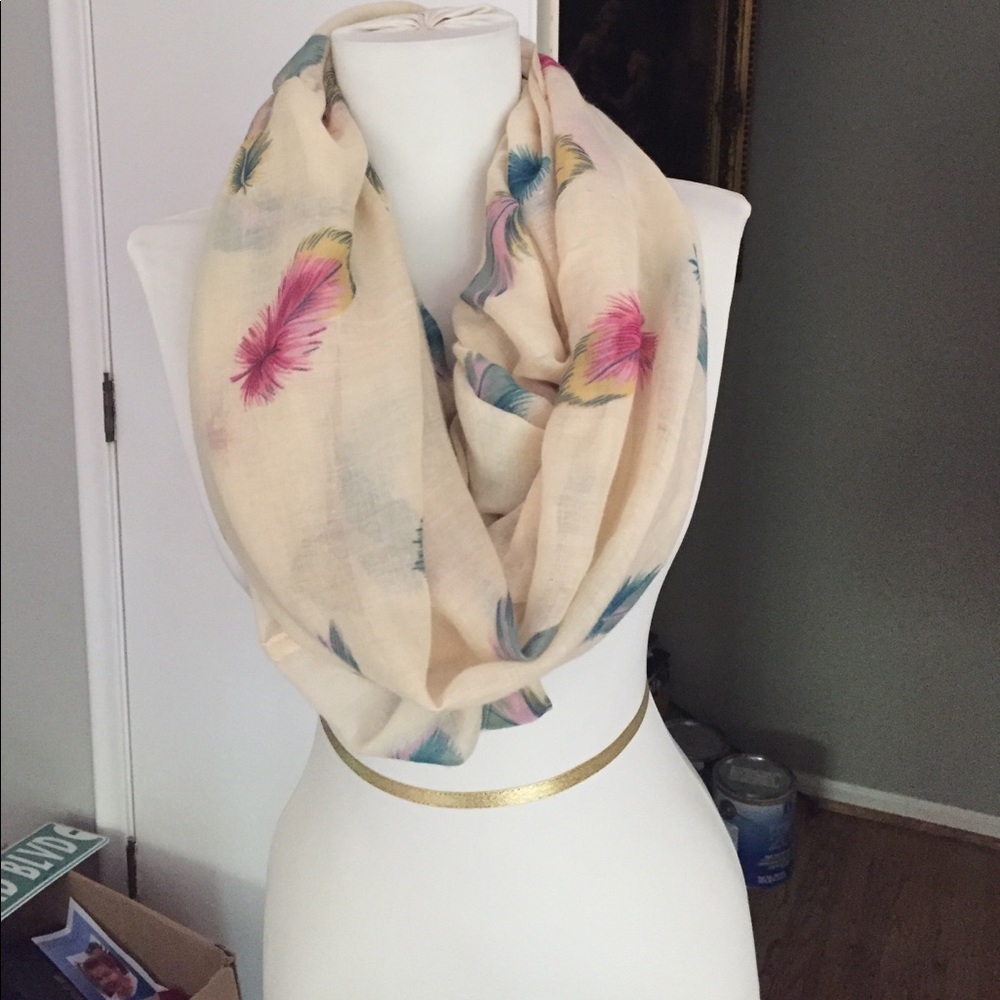 Sheer cream colored feather print infiniti scarf.