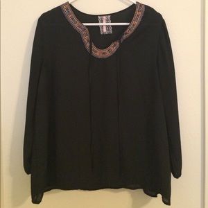 Embroidered flowy black top.