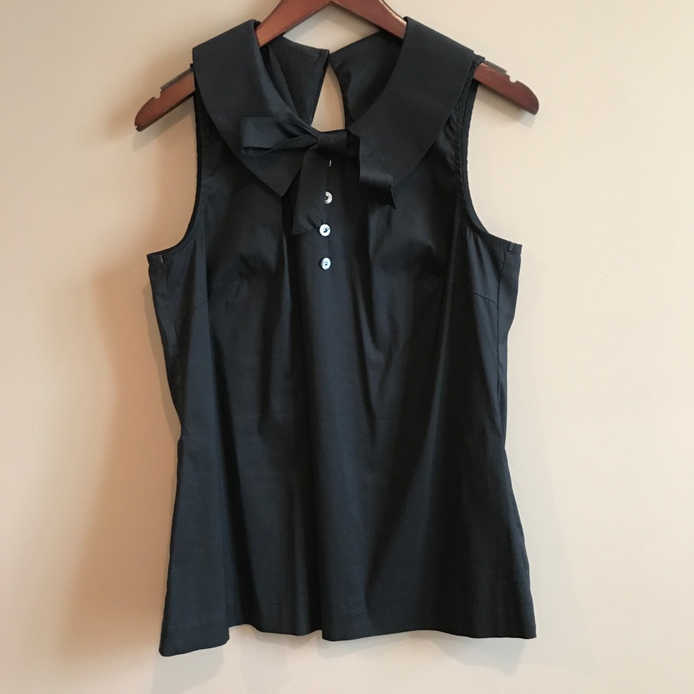 Black top with collar, buttons, and bow