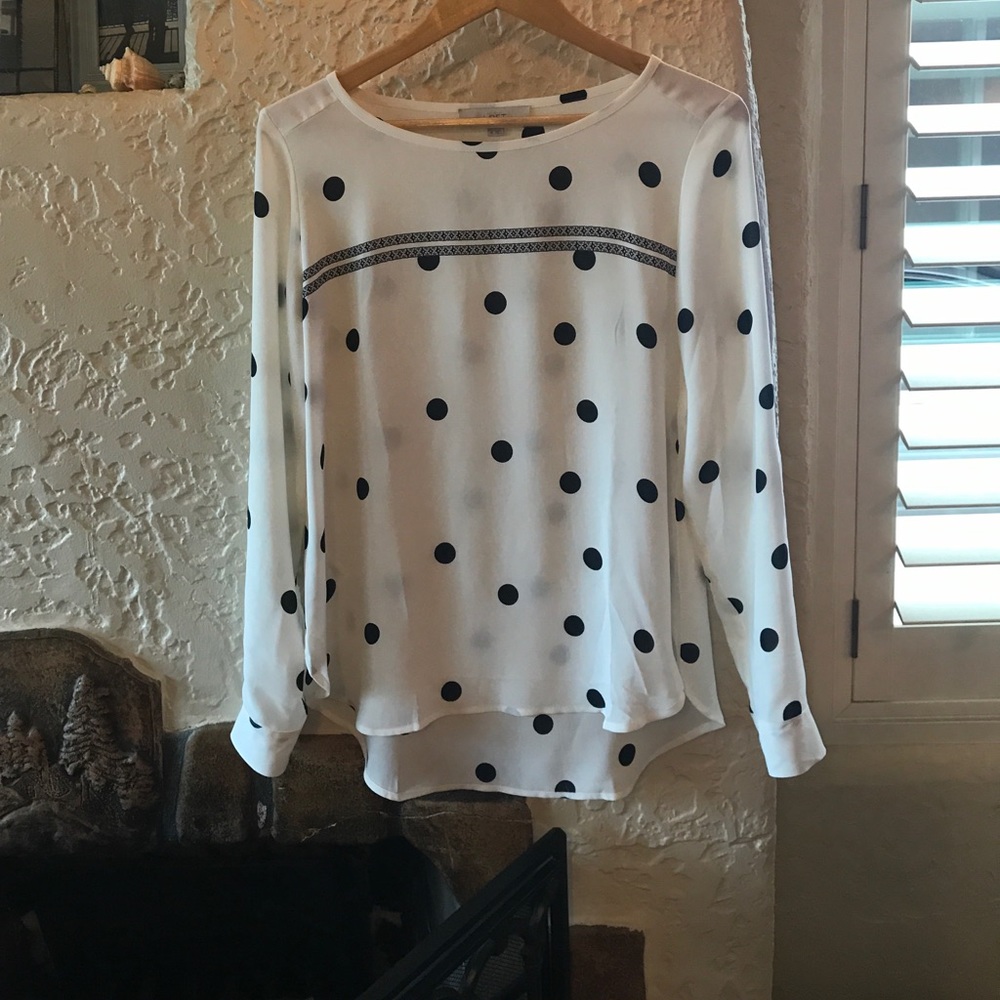 Cream color blouse  with black polka dots.