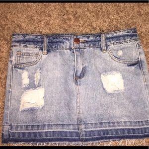 Blue denim distressed mini skirt