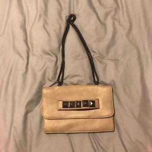Small purse with studs and chain strap.