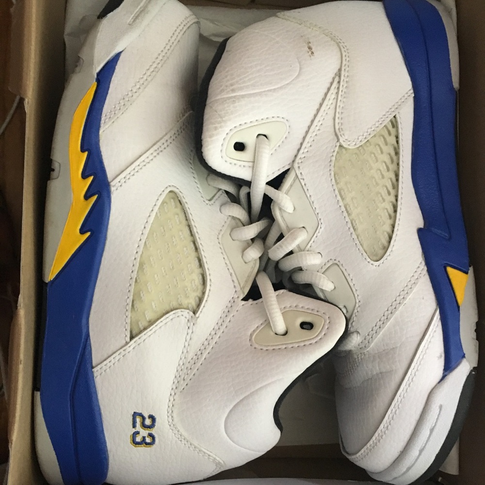 pair of white-blue-yellow Air Jordan 5's in box