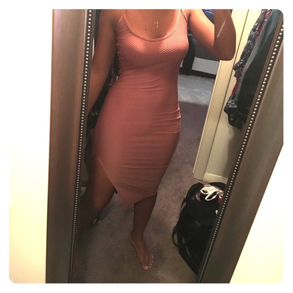 Ribbed blush color dress with a slit in leg.