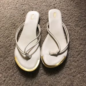 White flip flops with gold accents