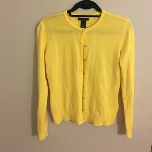 Soft yellow cardigan with diamond-style buttons