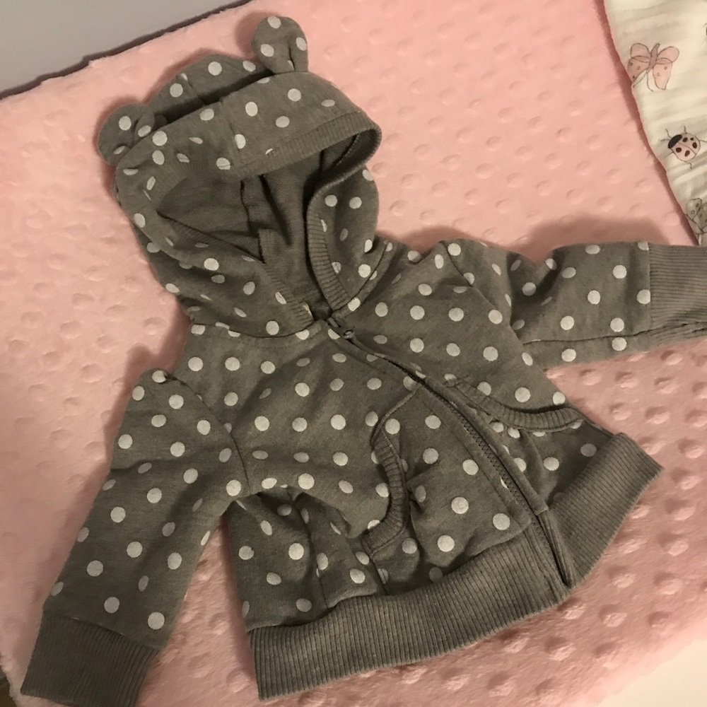 Grey and white polka dot zip-up sweatshirt.
