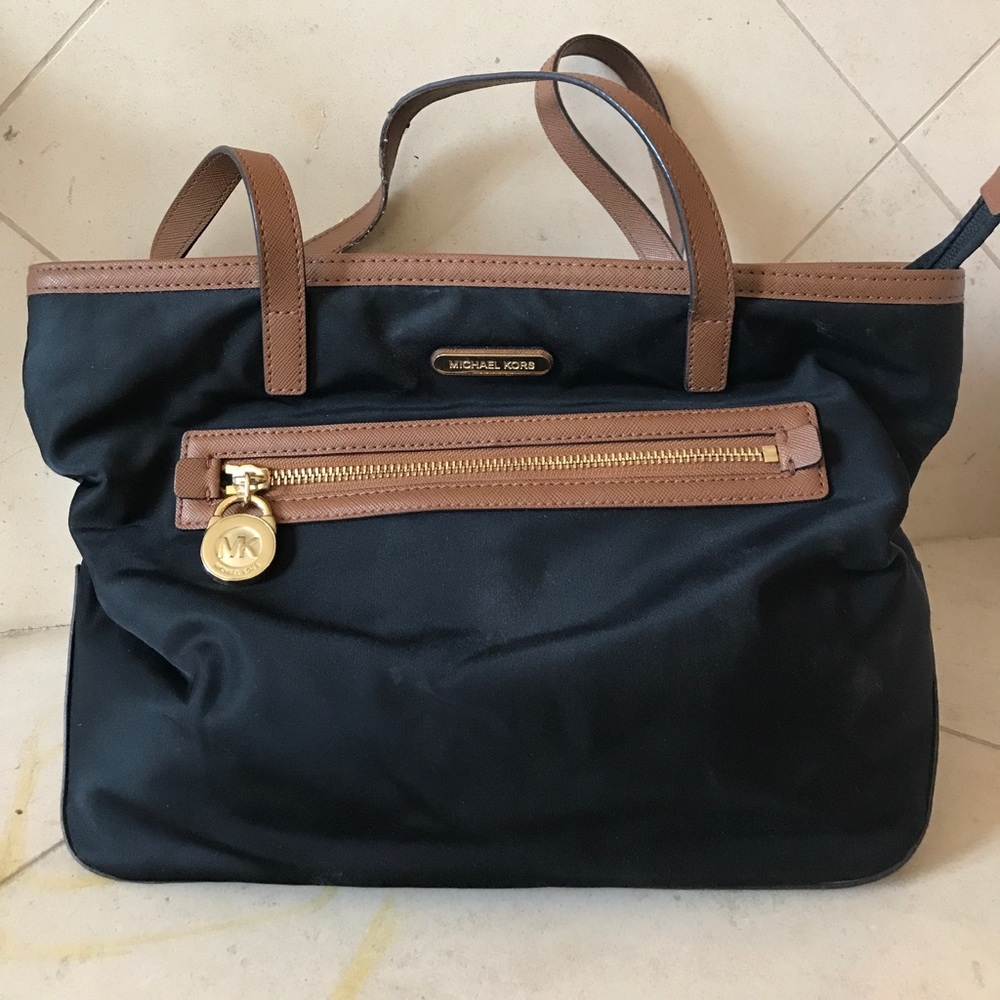 Black Michael Kors bag with leather lining.