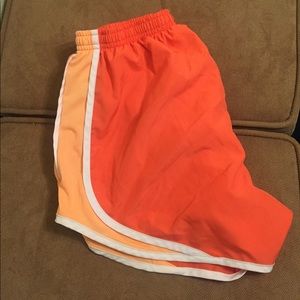 Nike Dri-Fit running shorts orange and white