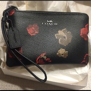 Black and floral coach wristlet