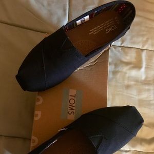 Toms new, unused, in original box without tags.