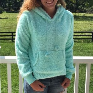 Fuzzy fleece hooded sweatshirt in aqua.