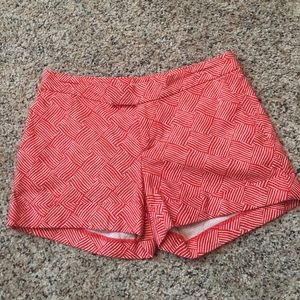 Orange and white geometric print shorts