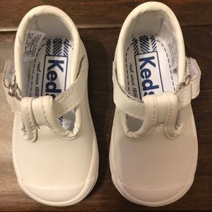 Infant Keds white T-strap shoe.